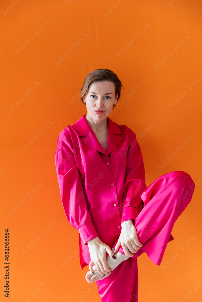 Beautiful fashionable woman in crimson silk pajamas Beautiful fashionable woman in crimson silk pajamas