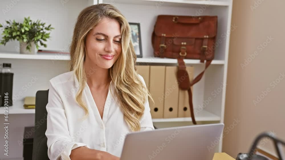 Confident, young blonde business woman brimming with positivity works ...