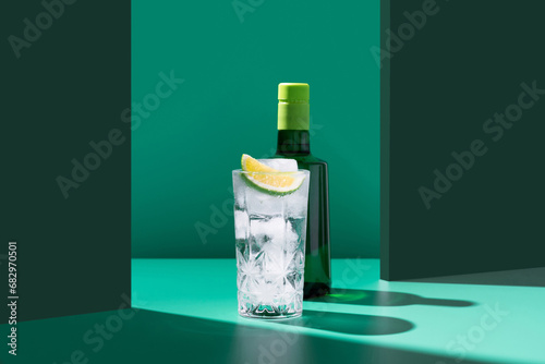 Artistic gin tonic cocktail setup with lime slice photo