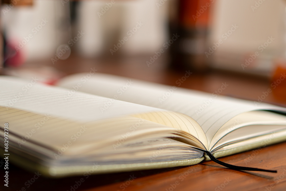 An open journal and warm light illuminating blank pages An open journal and warm light illuminating blank pages