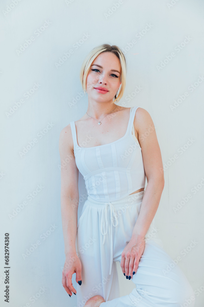 Portrait of a beautiful fashionable woman in white clothes Portrait of a beautiful fashionable woman in white clothes