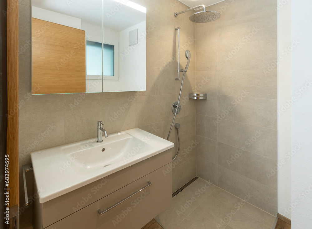 Modern bathroom interior with beige tiles and sleek fixtures Modern bathroom interior with beige tiles and sleek fixtures