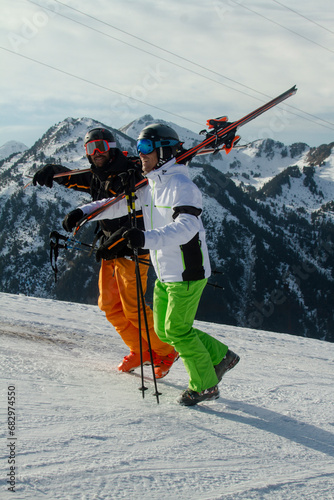 Two skiers walking with gear in the Swiss Alps photo