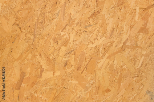 Chipboard light yellow osb surface pressed wooden pattern texture particleboard background construction material