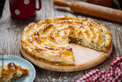 Fototapeta Naklejka Na Ścianę i Meble -  Traditional Bosnian and Turkish meal made from rolled pastry filled with spinach. In Turkey it is called Borek. In Bosnia this dish is called Pita Zeljanica. Made from phyllo 