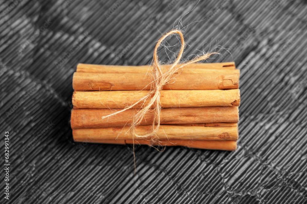 Cinnamon sticks bundle with rope. Aromatic seasoning.
