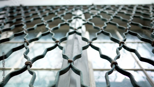 Foto Metal window fence protection patterns demarcating property separation in buildi