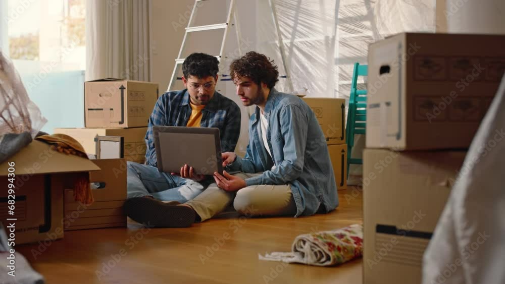 A young multi-ethnic couple of two boys use the computer to think about how to furnish their new house.
A young multi-ethnic couple of two boys use the computer to think about how to furnish their new house.