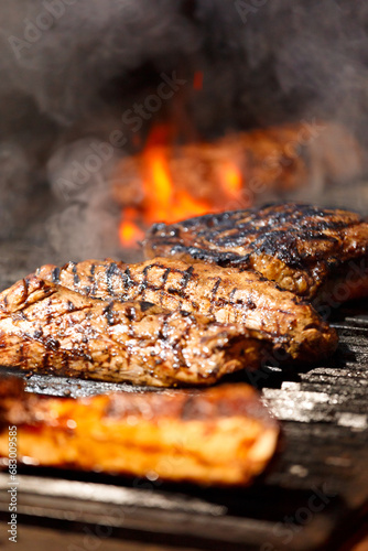Juicy meat steaks and fillets are grilled