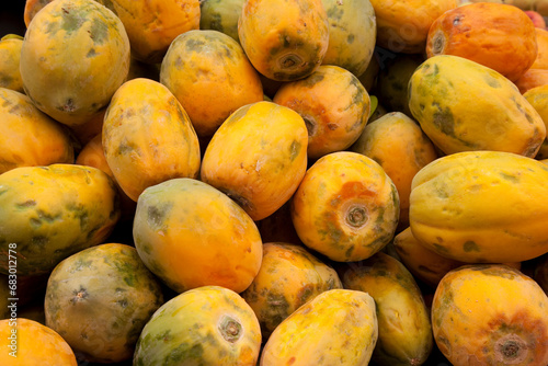 mature papaya fruits on the market photo