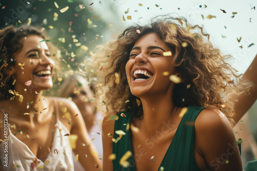 Exuberant young women laughing amidst a cascade of confetti in outdoor party. Generative AI. photo
