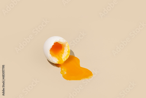Soft boiled egg, runny yolk on a beige background. 
