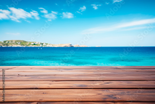 A wooden table set against the backdrop of the sea, an island, and the blue sky.Empty space for text. Bright image.