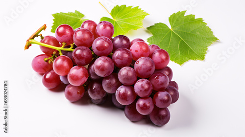 Isolated red grapes with green foliage viewed from above on a white background.