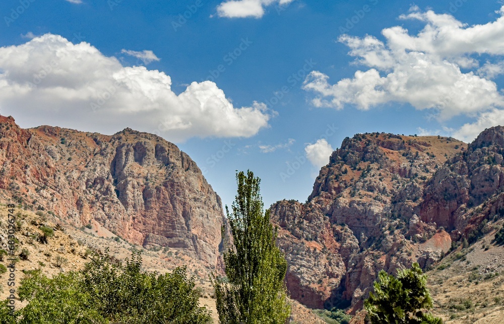 Nature landscape with cliffs, rocks, tree and clouds on sky