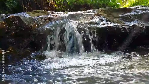 watercourse with a small waterfall, close-up