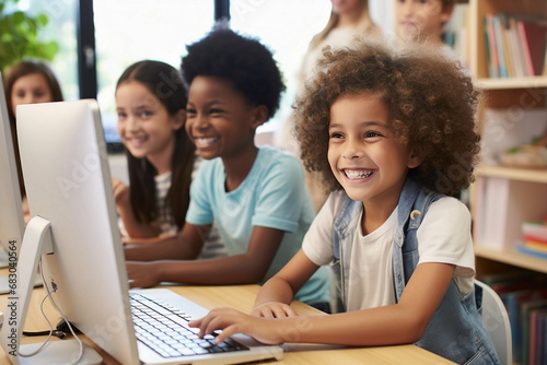 group of children learning on laptop in classroom