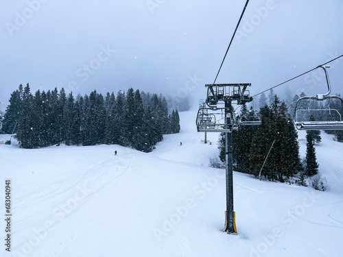 Ski Lift snowy mountain winter forest with chair lift At The Ski Resort in winter. Snowy weather Ski holidays Winter sport and outdoor activities Outdoor tourism © anna.stasiia