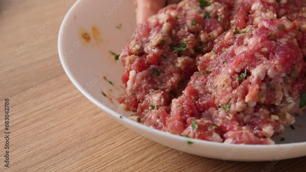 Close-up shot of Hands Mixing Ground Meat, a Step in Meatball Making. Close-up shot of Hands Mixing Ground Meat, a Step in Meatball Making.