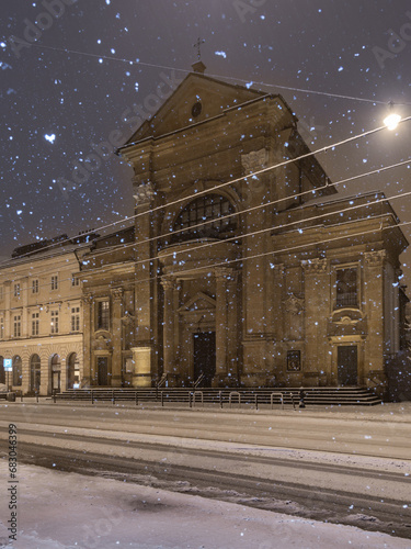 Baroque Vincentians church on Stradom street during snowy night, Krakow, Poland photo