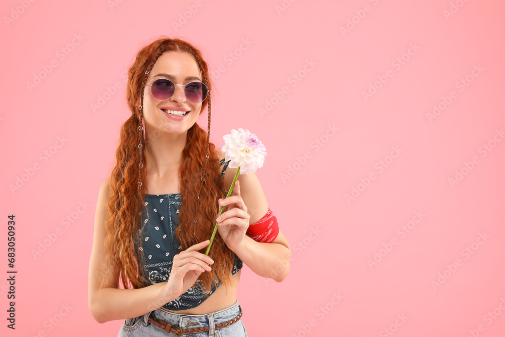 Stylish young hippie woman with dahlia flower on pink background, space for text Stylish young hippie woman with dahlia flower on pink background, space for text