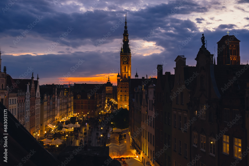Beautiful old town in Gdansk at summer dusk Poland. Sunset night view from the window rooftop on historical centre Dluga street and city hall architecture buildings St Mary Basilica. Travel attraction
