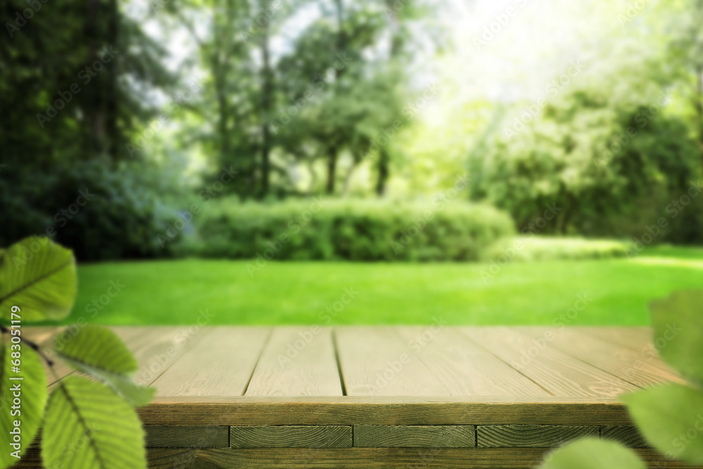 Empty wooden table in park on sunny day. Space for design Empty wooden table in park on sunny day. Space for design