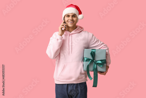 Smiling young man in santa ...