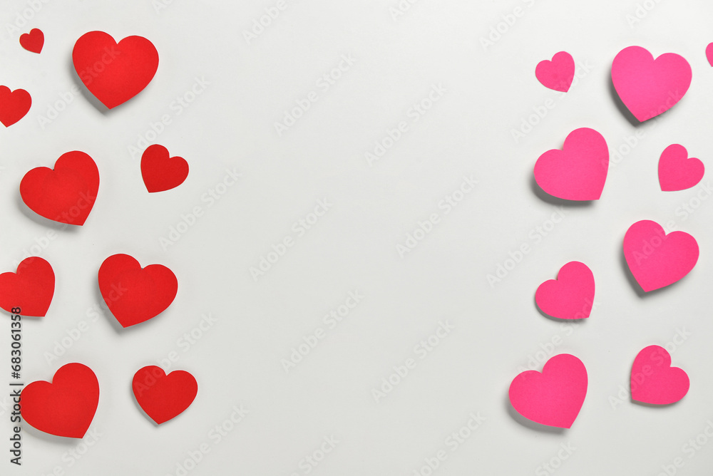 Romantic composition with red and pink paper hearts on white background. St. Valentine's Day.