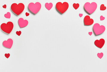 Romantic composition with red and pink paper hearts on white background. St. Valentine's Day.
