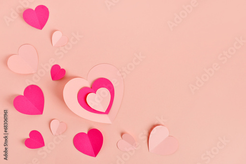 Composition with different paper hearts on pink background