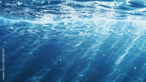 Black water with ripples on the surface. Defocus blurred transparent blue colored clear calm water surface texture with splashes and bubbles. Water waves with shining pattern texture background © vannet