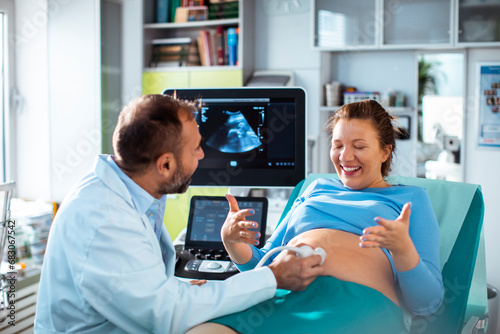 Pregnant woman undergoing ultrasound test at hospital by doctor