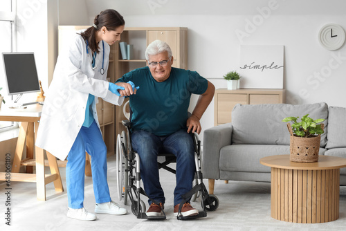 Nurse helping senior man to...