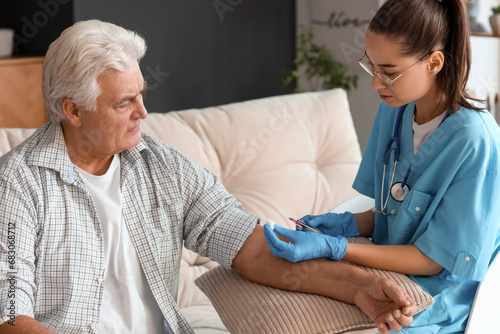 Nurse taking blood from sen...