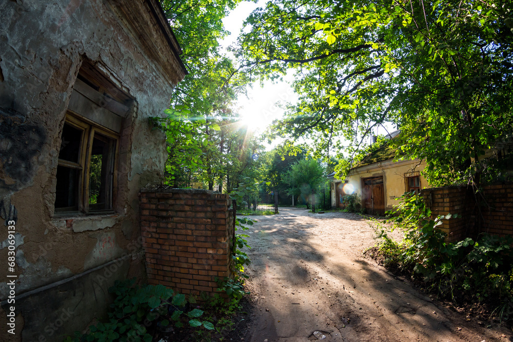 Abandoned checkpoint with a brick security booth surrounded by green thickets Abandoned checkpoint with a brick security booth surrounded by green thickets