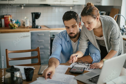 Young couple reading bad financial report having financial debt at home photo