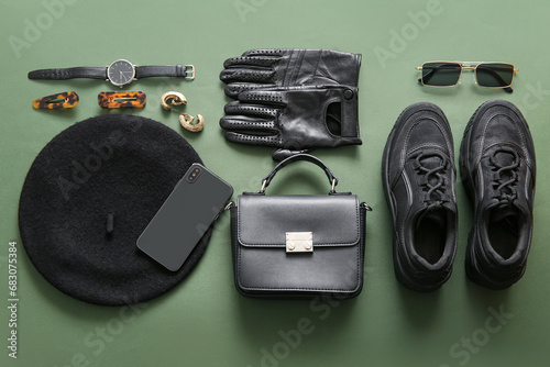 Composition with different female accessories, shoes and modern mobile phone on green background