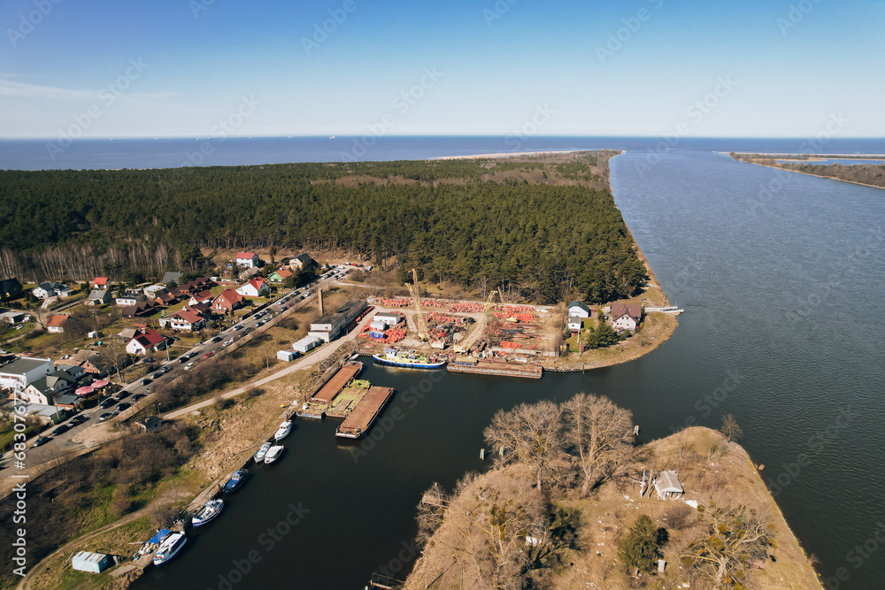 Yacht marina in harbour Sobieszewo Island. Aerial Drone view of the green district of Gdansk located on the Vistula River in spring. 