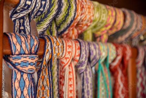 Many colorful belts with patterns. Folk art, handmade, Knitting of a traditional ethnic latvian folk belt