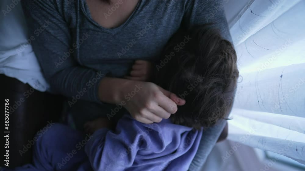 Child feeling comfortable in mother lap. Mom caresses son hair showing tenderness and love. Motherhood affection concept Child feeling comfortable in mother lap. Mom caresses son hair showing tenderness and love. Motherhood affection concept