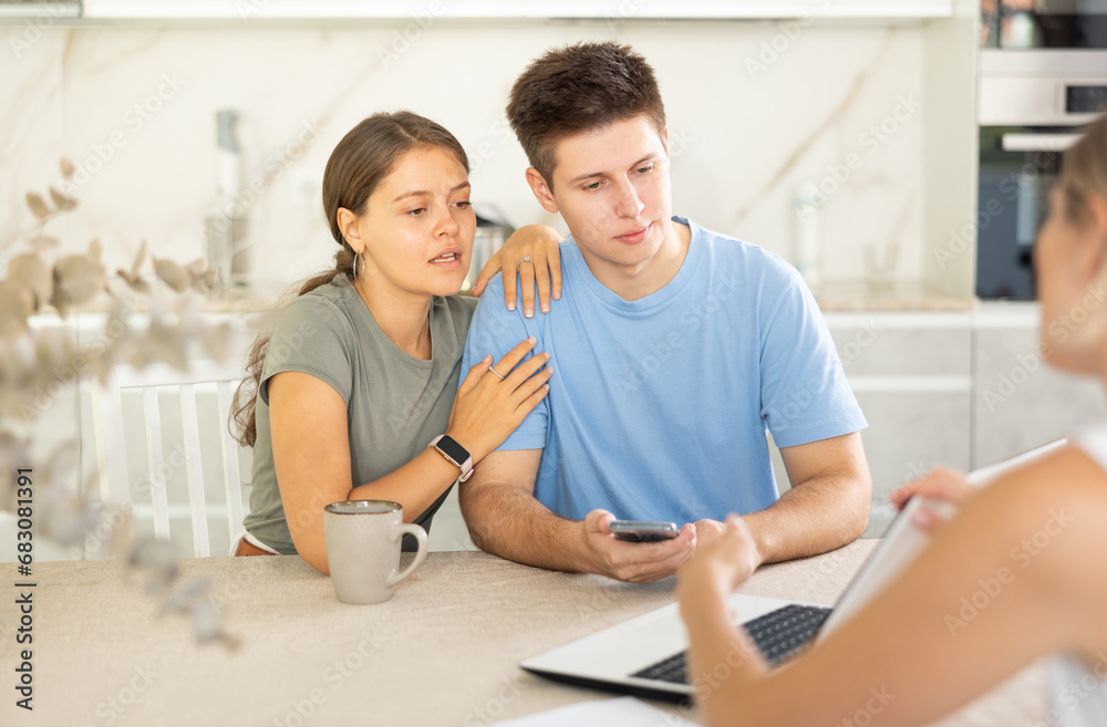 Fototapeta premium Married couple during conclusion of transaction, clients consult with manager about terms of cooperation, amount of payments on deposit