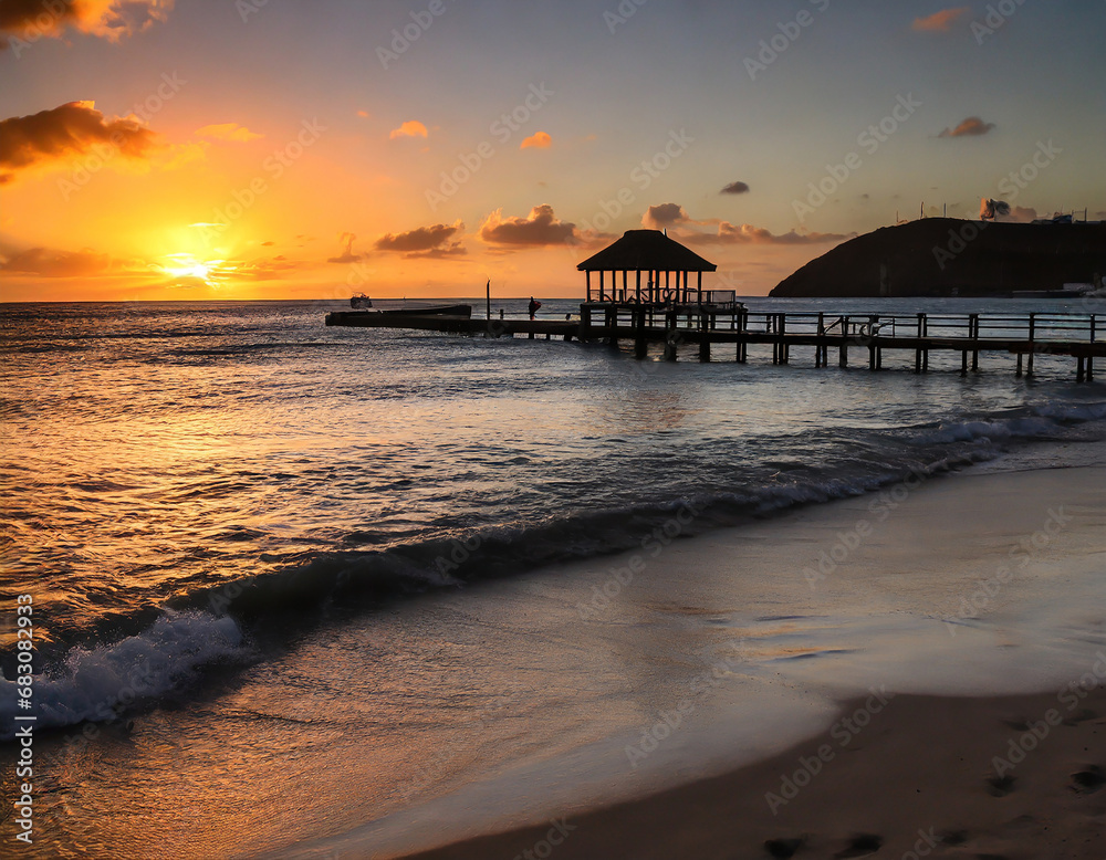 sunset over the beach with a pier in st martin