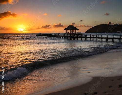 sunset over the beach with a pier in st martin