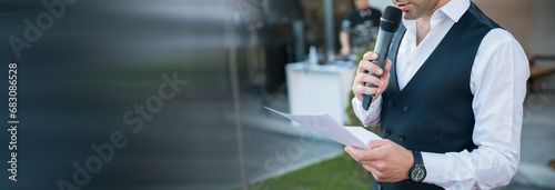 Photos speaker hand paper and microphone