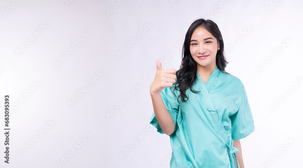 Cheerful patient asian woman showing thumb up smiling on white background. Diagnosis patient young girl checkup holding thumbs up good healthy over isolated. Insurance health care and accident concept Cheerful patient asian woman showing thumb up smiling on white background. Diagnosis patient young girl checkup holding thumbs up good healthy over isolated. Insurance health care and accident concept