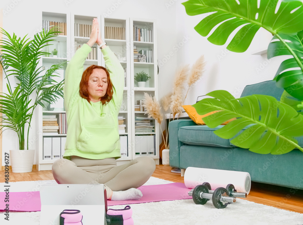woman doing yoga and stretching exercises in her home. sport at home.