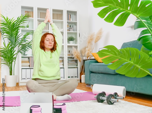 Obraz na płótnie woman doing yoga and stretching exercises in her home. sport at home. w salonie