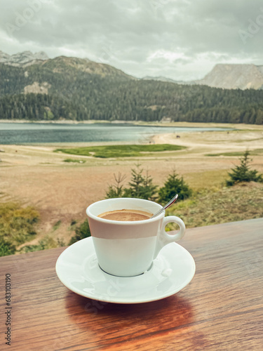 Сup of espresso on a cafe table overlooking the Black Lake
