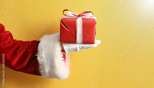 Image of hand of santa claus holding christmas gift with copy space background. Christmas, tradition and celebration concept. christmas Photo of Santa Claus gloved hand with giftbox 